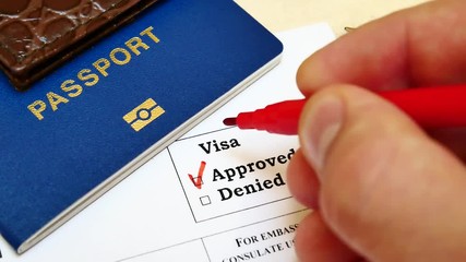 The decision to grant a visa. Pen voting approved in checkbox in blank visa application form
