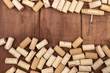 Wine corks and a corkscrew on a dark wooden background with a place for text