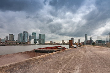 Old rusty ship moored in Canary Wharf in London