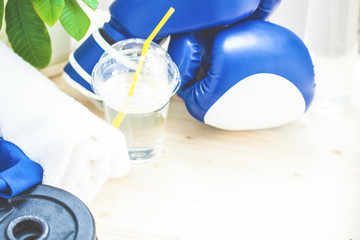 set for sports, towel, boxing gloves, dumbbell and a bottle of water on a light background The concept of a healthy lifestyle. Copy space