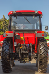 Tractor for farm work, modern agricultural transport working in the field, modern tractor close-up