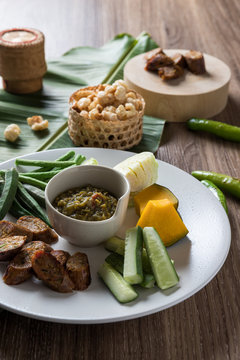 Thai northern food. Nam Prik Num (Northern Thai Green Chilli Dip), Streaky pork with crispy crackling, Sai aua (spicy sausge) and vagetable