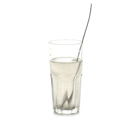 A glass of salt of soda for rinsing teeth on a white background isolation