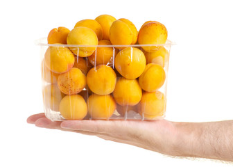 Apricots in a basket orange fruit in hand on a white background isolation