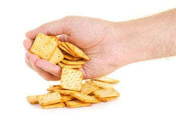 Cracker in hand on white background isolation
