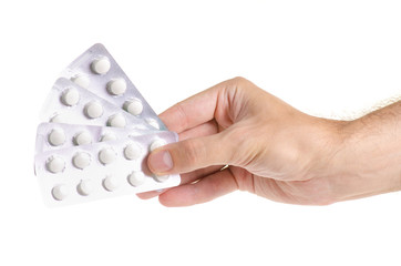 Medicine pills in blister, drug tablets in hand isolated on white background. Pharmacy and...