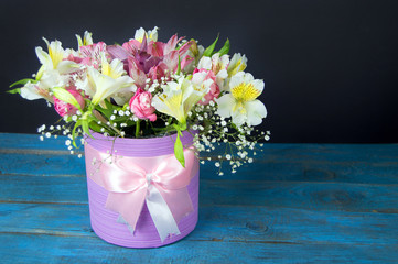 bright bouquet of alstroemeria, roses and greens on blue and bla