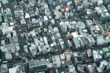 Aerial view of densely built City blocks seen from high angle perspective in Tokyo, Japan