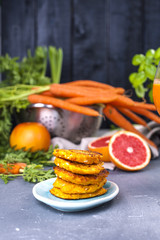 Juice from fresh carrots and grapefruit in a glass and fragrant pancakes for breakfast. vitamin drink for a healthy diet. Vitamins in food. Copy space.