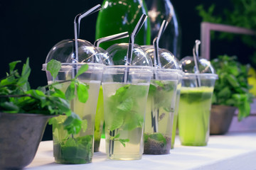 Natural mojito in plastic glasses close-up.