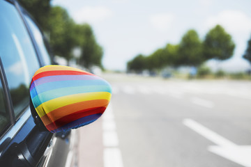 rainbow flag in the wing mirror of a car