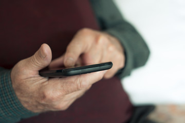 old caucasian man using a smartphone