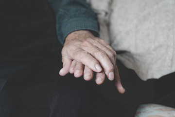 old man and old woman holding hands