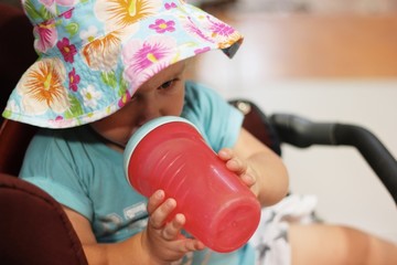 A toddler drinking a water 