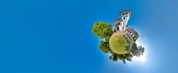 Green little planet with trees, soft blue sky and building. Tiny planet sunset near the castle. 360...