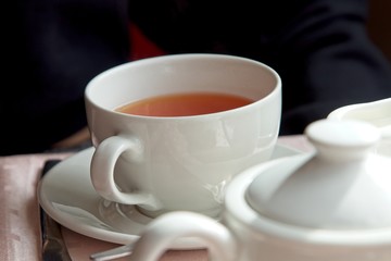 A cup of tea on a restaurant table.