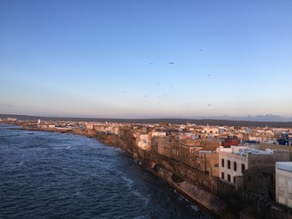 Obraz premium The sunset tones over the walled ancient city of Essaouira, Morocco from a sky view.