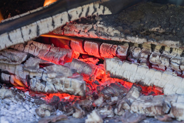 close up of burned charcoal in metal stove