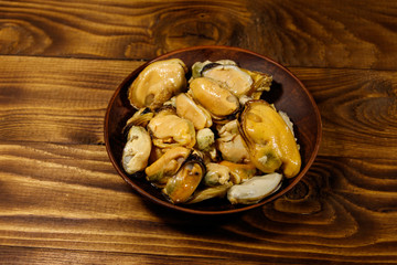 Marinated mussels on wooden table