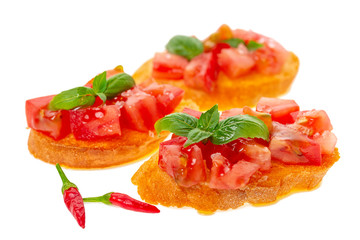 savory tasty chopped tomato on toasted baguette garnished with basil and peppers, Italian appetizers bruschetta, isolated on white background