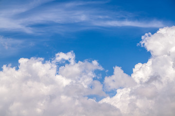 Naklejka na ściany i meble background of blue sky with fluffy white clouds 