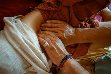 The hands of an experienced master. Advertising for medical centers. Alternative medicine. Osteopathy. Manual therapy. A woman at a doctor's reception. Work with digestion. Soft touch of the doctor.