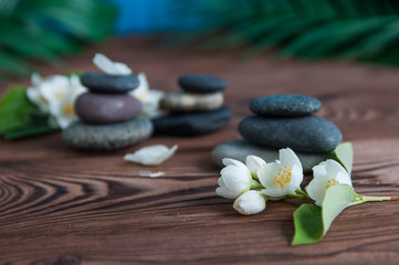 Pyramids of gray zen stones with beautiful fresh white flowers. Concept of harmony, balance and meditation, spa, massage, relax