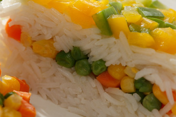 Healthy vegetarian food. Rise basmati with vegetables. Vegan food. Basmati rice cooked white on wooden table.