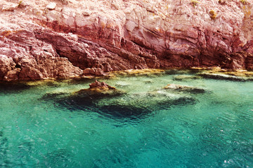 Fototapeta na wymiar A view of a crystal clear Aegean sea and rocks in the island of Patmos, Greece