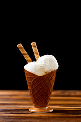 Ice cream stands on a brown wooden table. Copy space.