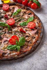 Italian pizza on black dough. Trendy food