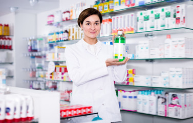 Glad female pharmacist offering products