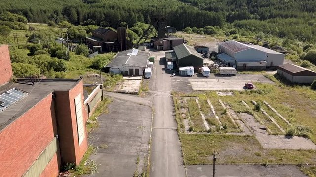 Aerial drone view of an abandoned, disused coal mine and machinery (Tower Colliery, Wales)