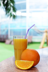 fresh orange juice with lemon and orange in a glass