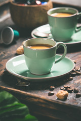Cups of coffee and capsules