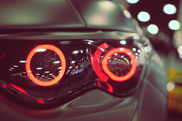 Luxury car headlight close-up. Concept of expensive, sports auto.  The concept of tuning. Headlight...