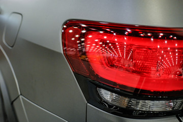 Luxury red car headlight close-up. Concept of expensive, sports auto.  The concept of tuning....