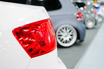 white car headlight close-up. Concept of expensive, sports auto.  The concept of tuning. Headlight...