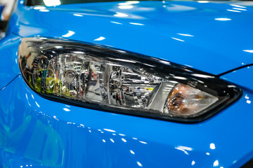 Luxury blue car headlight close-up. Concept of expensive, sports auto.  The concept of tuning....