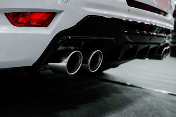 Close up of tuning white car exhaust pipe.