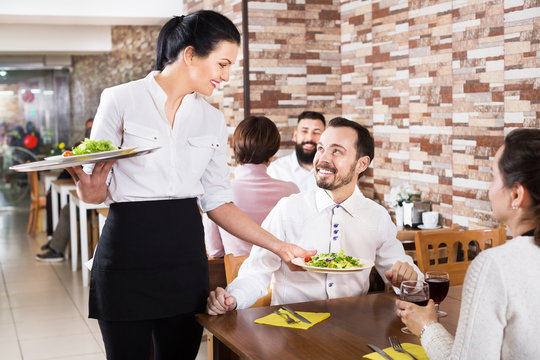 Waitress taking table order at tavern