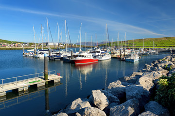 Colorful fishing boats and yachts at the harbor of Dingle town on the West Atlantic coast of...