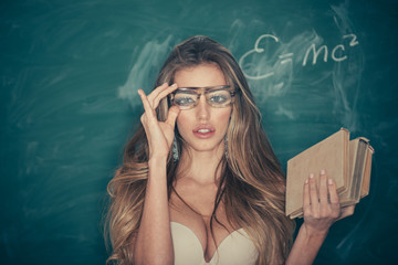 Confident and sexy teacher. Sensual woman adjust glasses on makeup face. School and education for adult. Woman with long blond hair in bra pose at chalkboard. Sexi bookworm. Back to school - obrazy, fototapety, plakaty