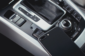 smartphone with dual camera in the interior of a modern car