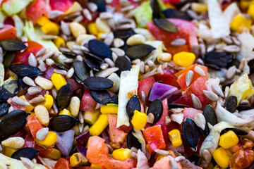 Healthy salad with cabbage, tomatoes, corn and pumpkin seeds