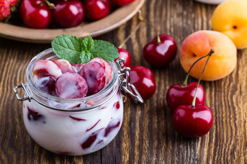 Healthy breakfast with sweet cherry yogurt and fresh  summer fruits