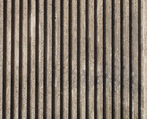 textured cast concrete wall with vertical lines and stripes