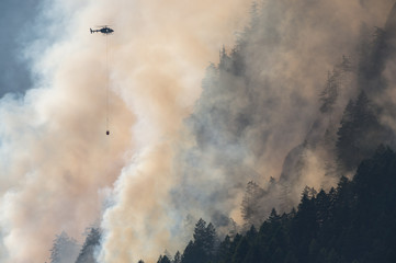 Mountain wood fire with Fire department helicopter