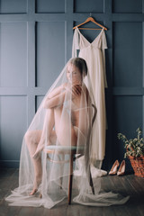 girl sitting chair covered veil bride white dress