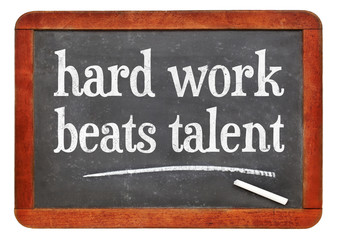 Hard work beats talent - text on blackboard